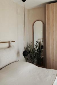 a bedroom with a bed and a mirror and a plant at lo͝or luxury retreat in Split
