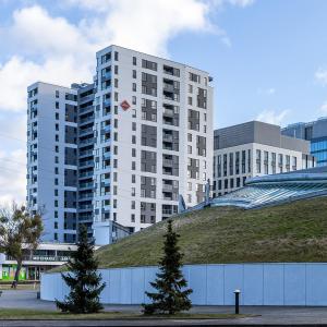 a building with a grassy hill in front of a building at Apartament Arena Gdynia in Gdynia