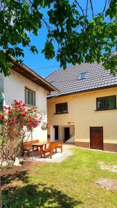 a house with a picnic bench in the yard at Apartma Metka Bovec in Bovec