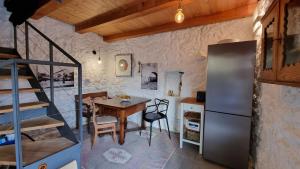 a kitchen and dining room with a table and a refrigerator at House Agava in Veliko Grablje