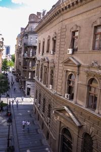 people walking down a street next to a building at Apartment Petra 073 in Belgrade