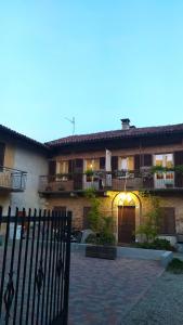 a house with a fence in front of it at La Vispa Ceresa in Castellinaldo