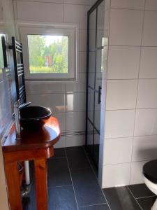 a bathroom with a sink and a window at Ta det lugnt in Råda
