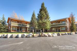 a large building with trees in front of it at Outstanding Top Floor Condo, Stunning Updates with Meticulous Touches Throughout PM7C in Breckenridge