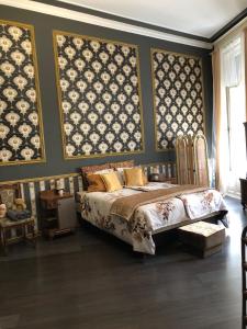 a bedroom with a bed and paintings on the wall at Secession Luxury Apartment in Budapest
