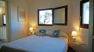 a bedroom with a bed with two pillows and a mirror at La Maddalena Exclusive villas in La Maddalena
