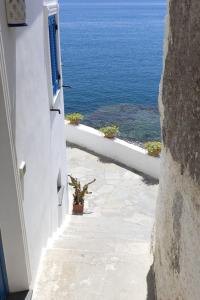 a view of the ocean from a white building at Casa Borgo Sant'Angelo in Ischia