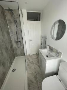 a bathroom with a shower and a toilet and a sink at Taylor’s Retreat in Radipole