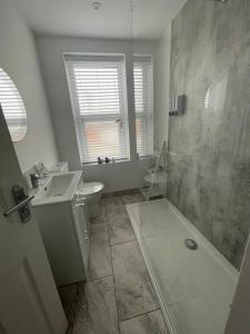 a bathroom with a shower and a toilet and a sink at Taylor’s Retreat in Radipole
