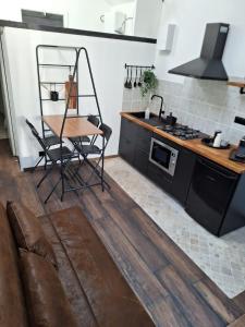 una cucina con tavolo e sedia in una stanza di au p'tit logis montlouisien a Montlouis-sur-Loire