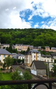 a view of a town with houses and trees at Appartement chaleureux et cosy in Le Mont-Dore