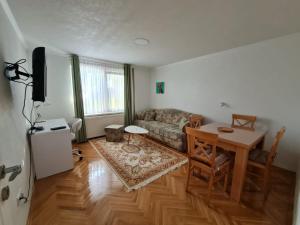 a living room with a couch and a table at Apartment Alemina 3min away from center in Cazin