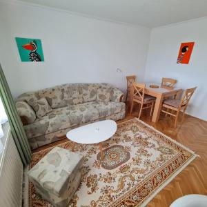 a living room with a couch and a table at Apartment Alemina 3min away from center in Cazin