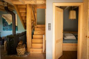 a room with a wood stove and a bedroom at Lubia Apartments baltic sea, garden ,parking ,dog firendly, in Lubiatowo in Lubiatowo +113 photos