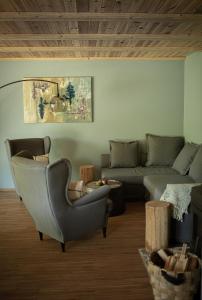 a living room with a couch and a chair at Lubia apartamenty nad morzem w Lubiatowie in Lubiatowo