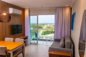 a living room with a couch and a table at Aqualand Park & Resort Oficial in Salinópolis