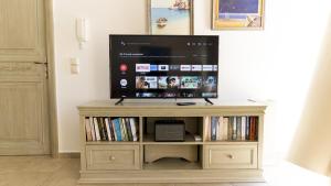 a flat screen tv sitting on top of a entertainment center at Triena Quality Villas in Gaios