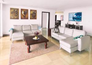 a living room with couches and a coffee table at Exclusive 3 BDR, Gym & Pool, SeaView, Luxury Tower in Santo Domingo