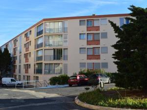 un edificio de apartamentos con coches aparcados en un aparcamiento en Appartement Banyuls-sur-Mer, 2 pièces, 4 personnes - FR-1-225C-4 en Banyuls-sur-Mer