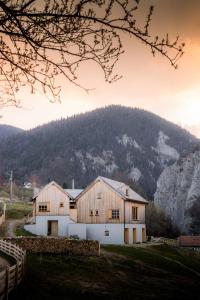 a barn with a mountain in the background at IKI Retreat Magura in Măgura