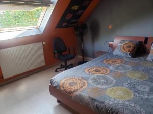 a bedroom with a bed and a chair and a window at WELCOME TO LE MANS in Le Mans