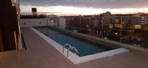 a swimming pool on the roof of a building at Edificio Hassler Villamorra in Asuncion