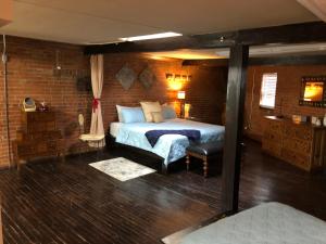 a bedroom with a bed and a brick wall at Dallas Farmers Market Area, Just right in Downtown in Dallas