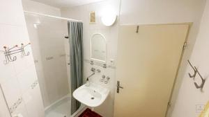 a white bathroom with a sink and a shower at Apartment Jursport in Závažná Poruba +42 photos