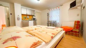 a bedroom with a bed with leaves on it at Apartment Jursport in Závažná Poruba