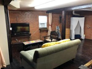 a living room with a couch and a flat screen tv at Dallas Farmers Market Area, Just right in Downtown in Dallas