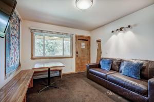 a living room with a leather couch and a table at Completely Renovated Unit, Trendy Top Floor with Many Onsite Amenities PM7D in Breckenridge