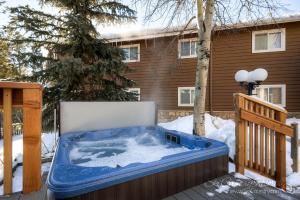 a hot tub in the snow in front of a house at Completely Renovated Unit, Trendy Top Floor with Many Onsite Amenities PM7D in Breckenridge