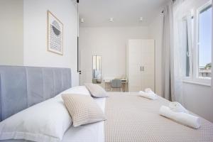 a white bedroom with two white towels on a bed at Luxury Rooms Zara&Ane in Split