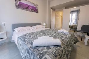 a bedroom with a bed with two towels on it at Casa Azzurra Vacanze in Porto San Giorgio