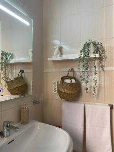 a bathroom with a sink and a toilet and towels at La Florida in Ciudad Real +17 photos