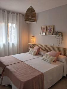 a bedroom with a large bed and a window at La Florida in Ciudad Real