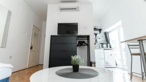 a living room with a table and a kitchen at House Gorica in Šibenik