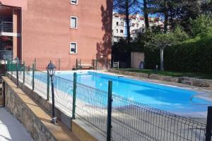 a large blue swimming pool next to a building at Casa Antonia Portosín in Portosin