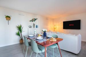 a dining room with a red table and chairs at MAISON SUR MER - Garage & Jardin Privè in Roquebrune-Cap-Martin