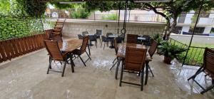 a patio with wooden tables and chairs on a patio at Palute in Supetar