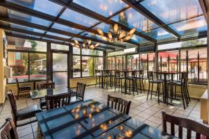 restauracja ze stołami, krzesłami i oknami w obiekcie Best Western Plus Placerville Inn w mieście Placerville