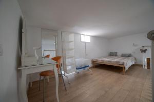 a white room with a bed and a desk and a bedroom at Casa Vacanze Lesina Gargano in Lesina +11 photos