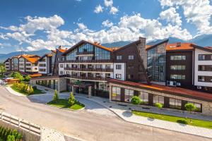 a group of buildings with mountains in the background at The Nature View Suite, part of Terra Complex & Spa in Bansko
