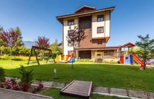 a house with a playground in front of a house at The Nature View Suite, part of Terra Complex & Spa in Bansko