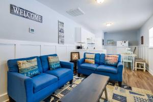 a living room with two blue couches and a table at Atlantic Beach Escape about 2 Mi to Barefoot Landing! in Myrtle Beach