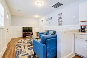 a living room with a blue couch and a tv at Atlantic Beach Escape about 2 Mi to Barefoot Landing! in Myrtle Beach