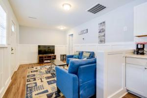 a living room with a blue couch and a tv at 2 Mi to Barefoot Landing! Baileys Beach Cottage in Myrtle Beach