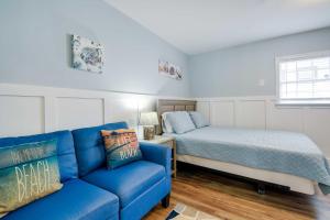 a living room with a couch and a bed at 2 Mi to Barefoot Landing! Baileys Beach Cottage in Myrtle Beach
