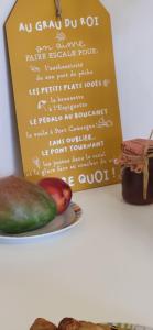 ein Schild neben einem Teller mit Essen in der Unterkunft La Caravelle 2 entre Plage et Centre Ville in Le Grau-du-Roi