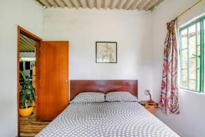 a bedroom with a bed with a wooden head board at Finca Umnisa - Choachi in Choachí
